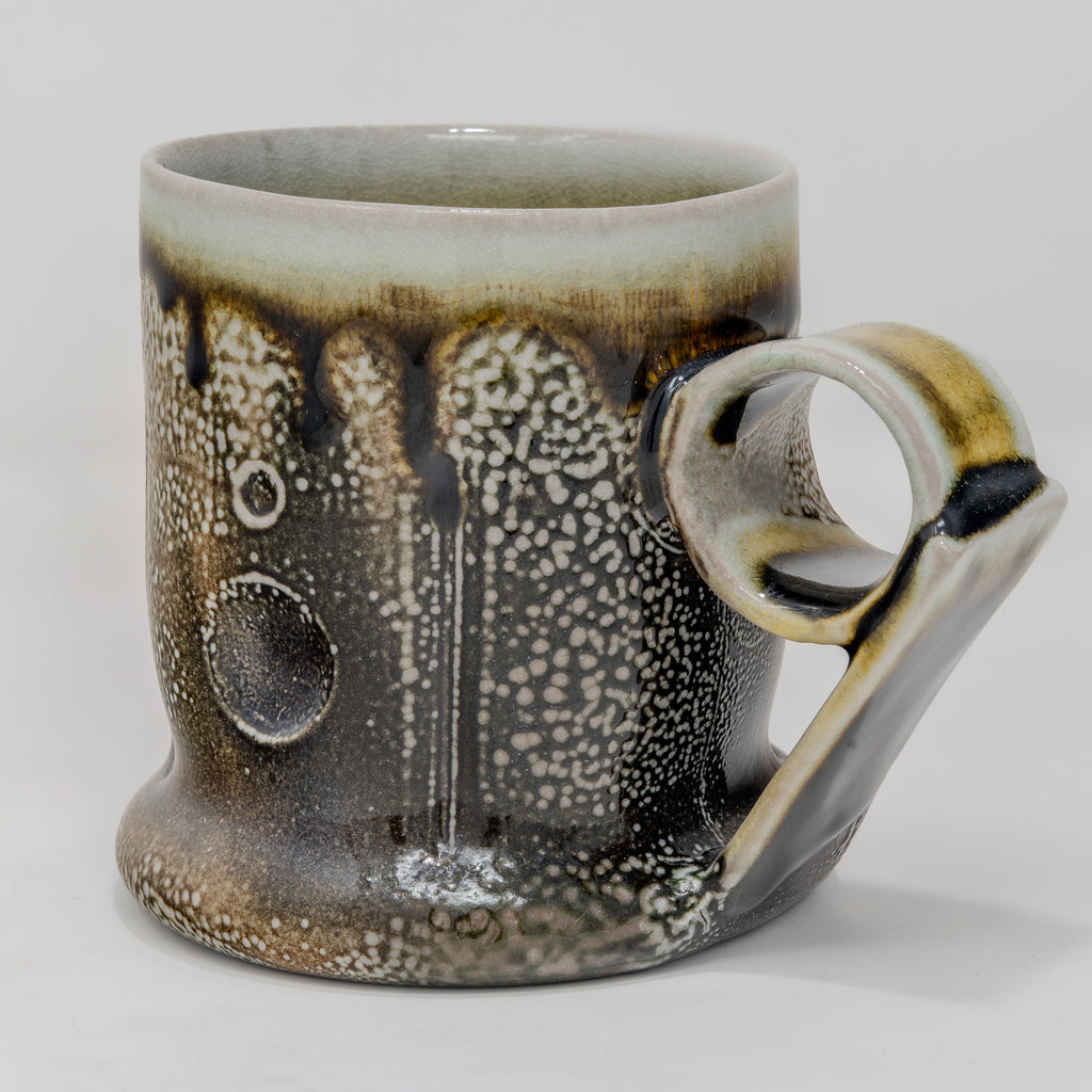Soda-fired Ceramic mug with speckled and handle on a white background