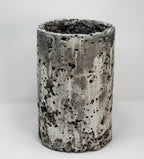 Cylindrical porcelain with textured surface on a white background