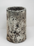 Cylindrical porcelain planter with textured surface on a white background