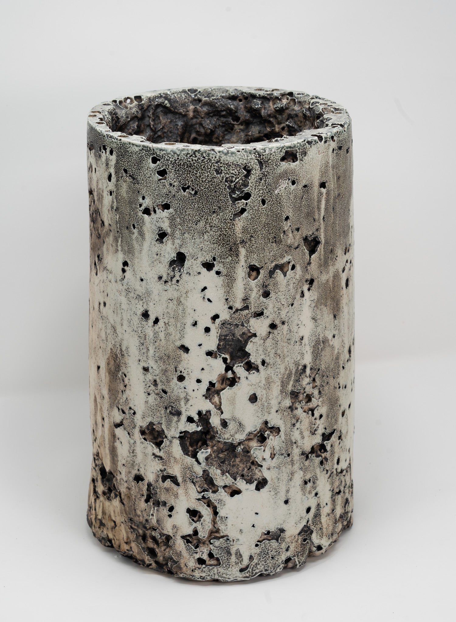 Cylindrical porcelain planter with textured surface on a white background